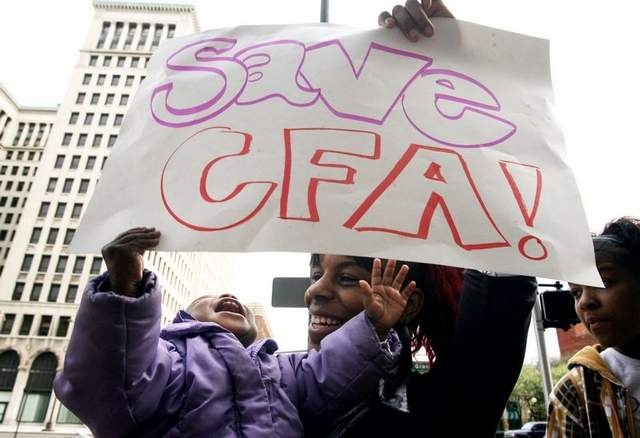 Brianna with baby and Save CFA poster